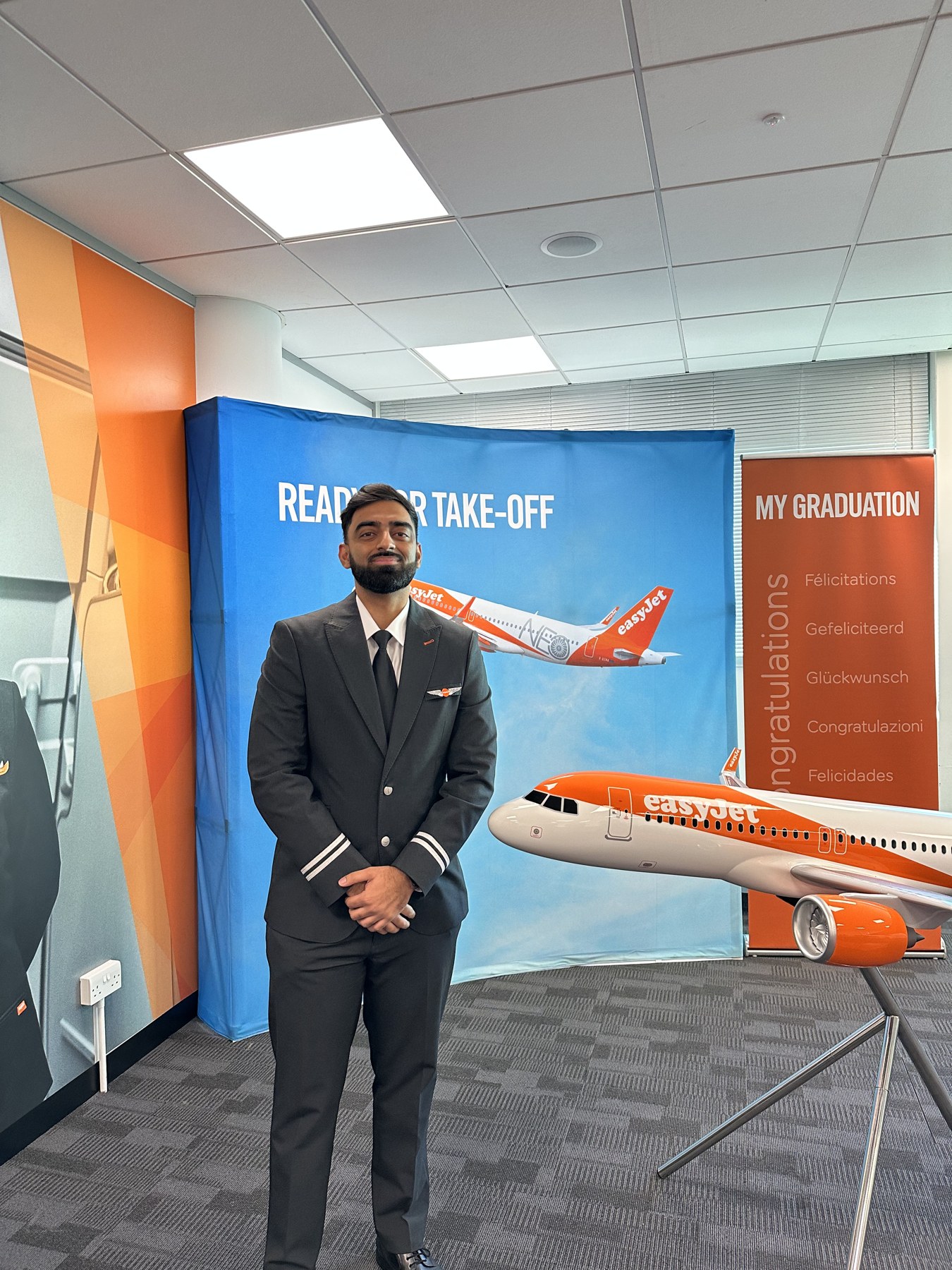 Mohamed Namaji in airline pilot uniform at his easyJet graduation